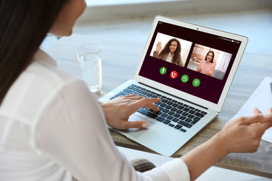 Woman having online meeting with her team via laptop, closeup