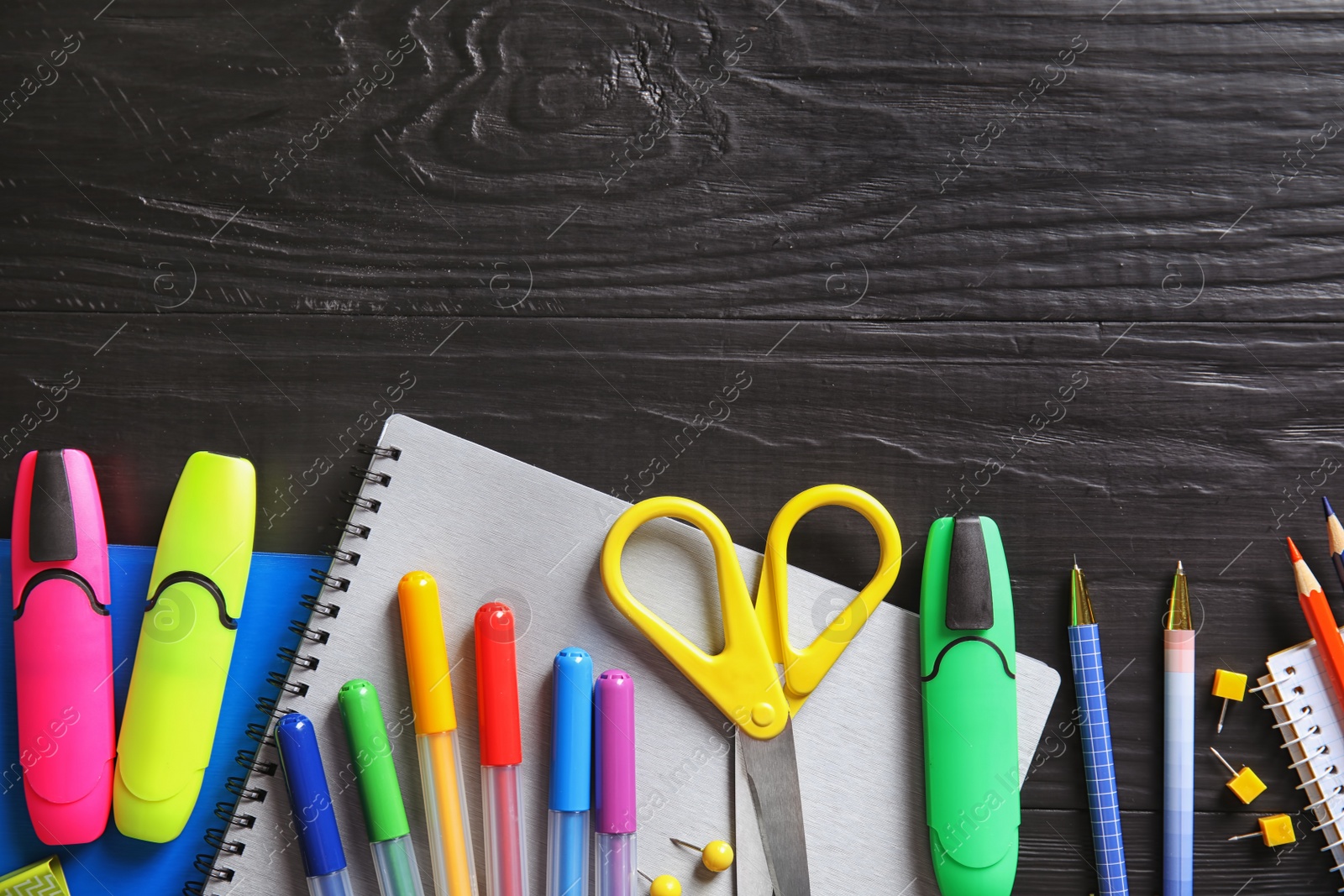 Photo of Different school stationery with space for design on wooden background, flat lay