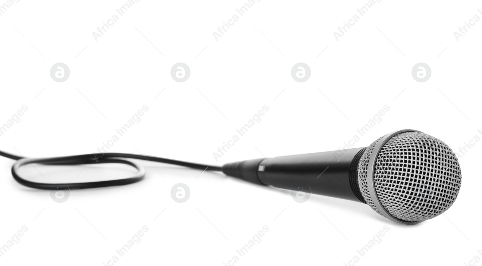 Photo of Professional dynamic microphone with wire on white background