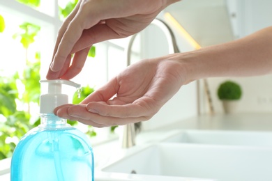 Woman applying antibacterial soap indoors. Personal hygiene during COVID-19 pandemic