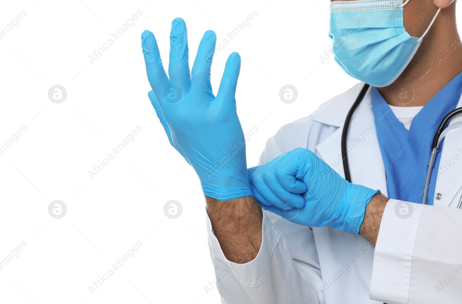 Photo of Doctor in protective mask putting on medical gloves against white background, closeup