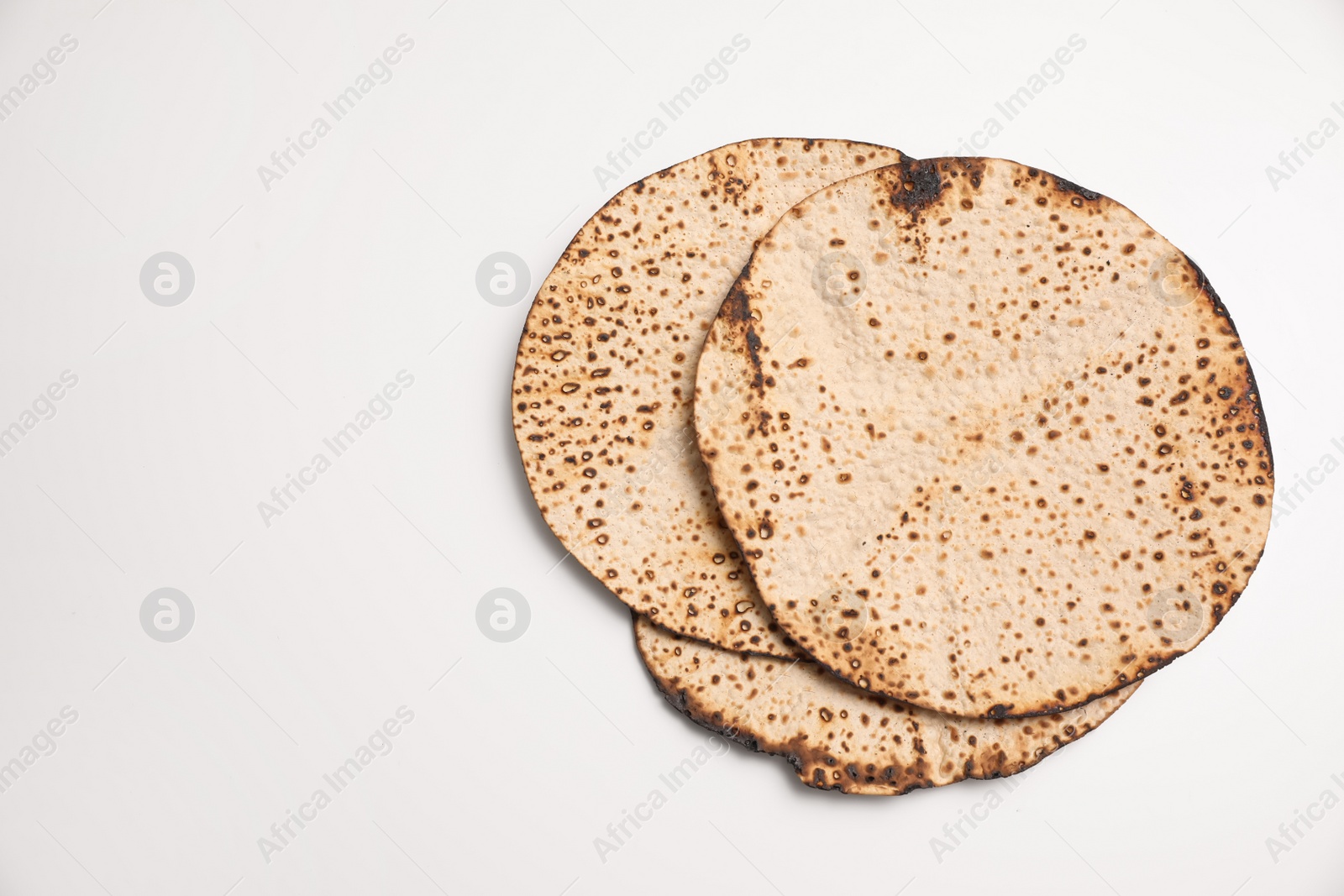 Photo of Tasty matzos on white background, top view. Passover (Pesach) celebration