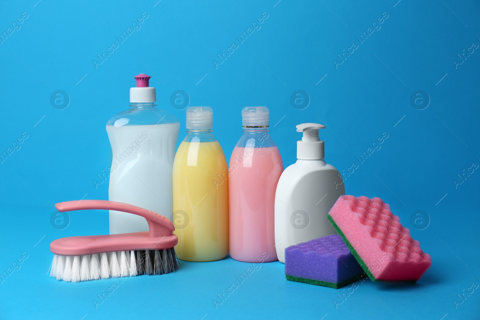 Photo of Cleaning supplies and tools on light blue background