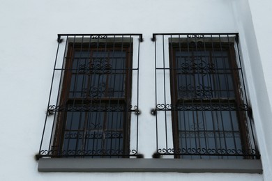 Photo of Exterior of building with beautiful window and steel grilles, low angle view