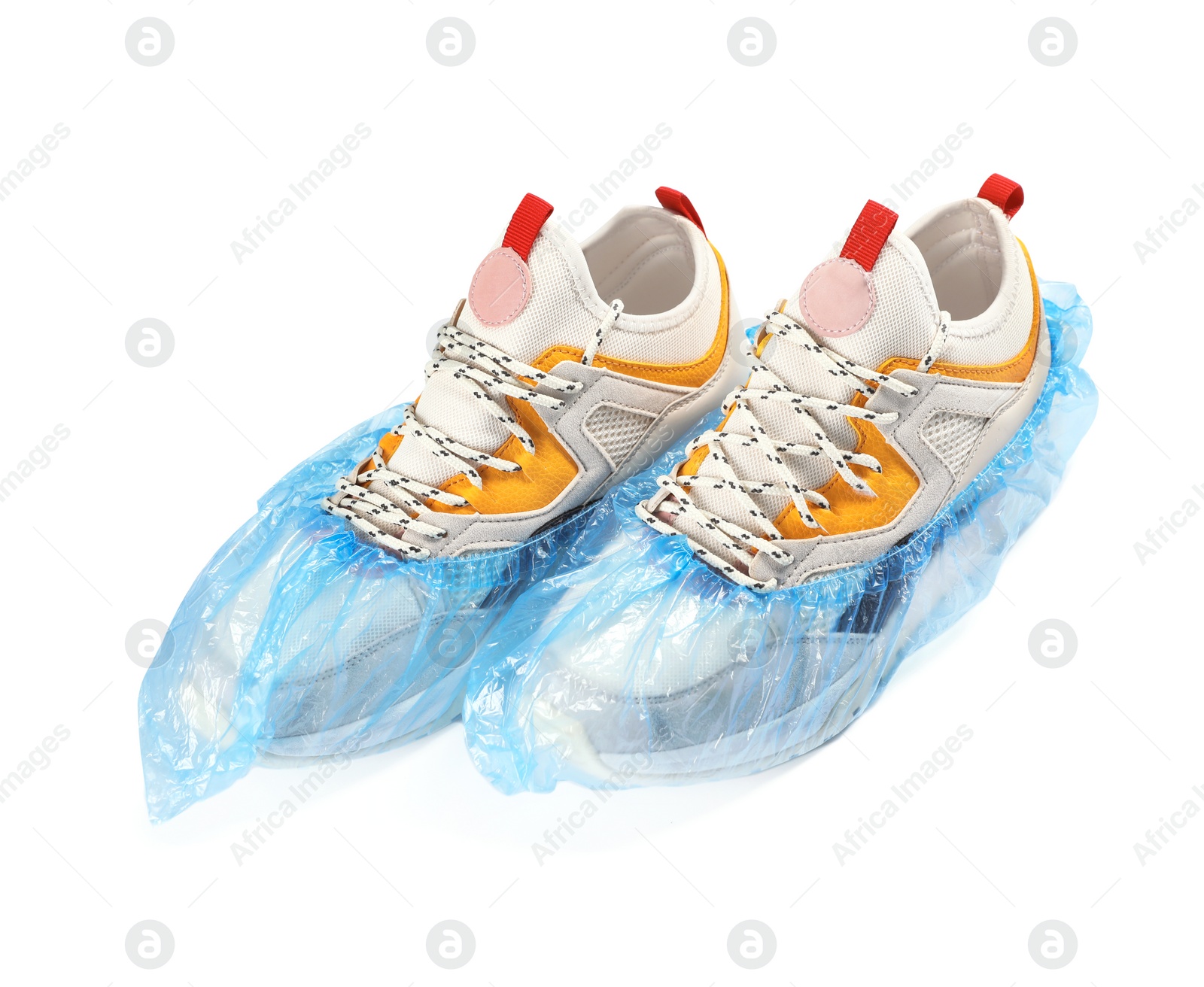 Photo of Pair of sneakers in medical blue covers on white background