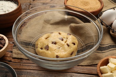 Fresh dough for cooking chocolate chip cookies on wooden table