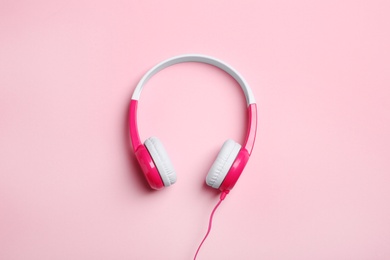 Stylish headphones on color background, top view