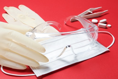Photo of Sterile gloves with medical items on color background
