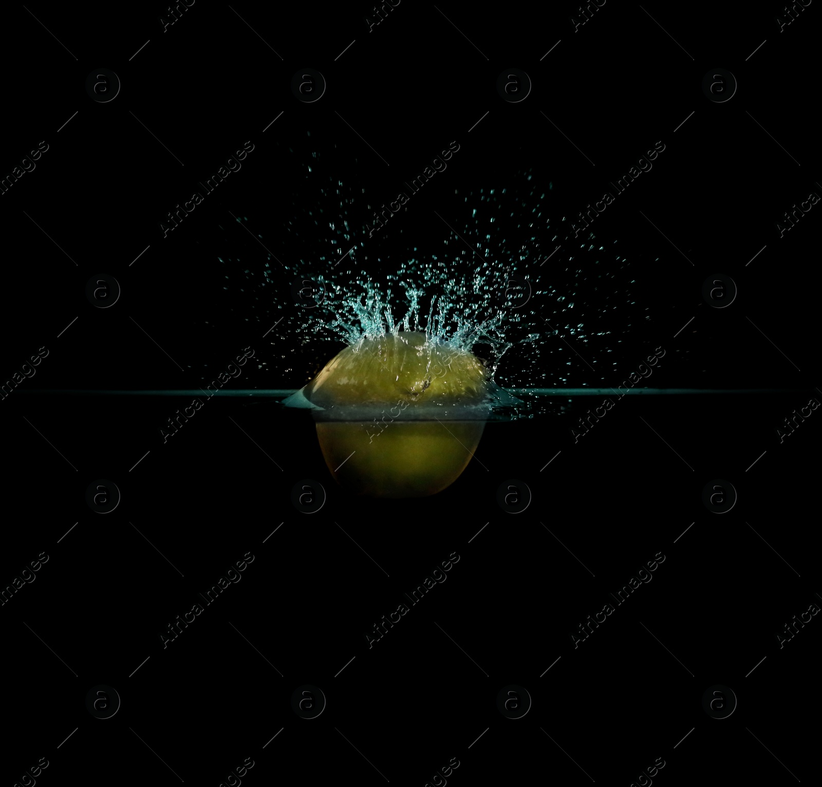 Photo of Apple falling down into clear water against black background