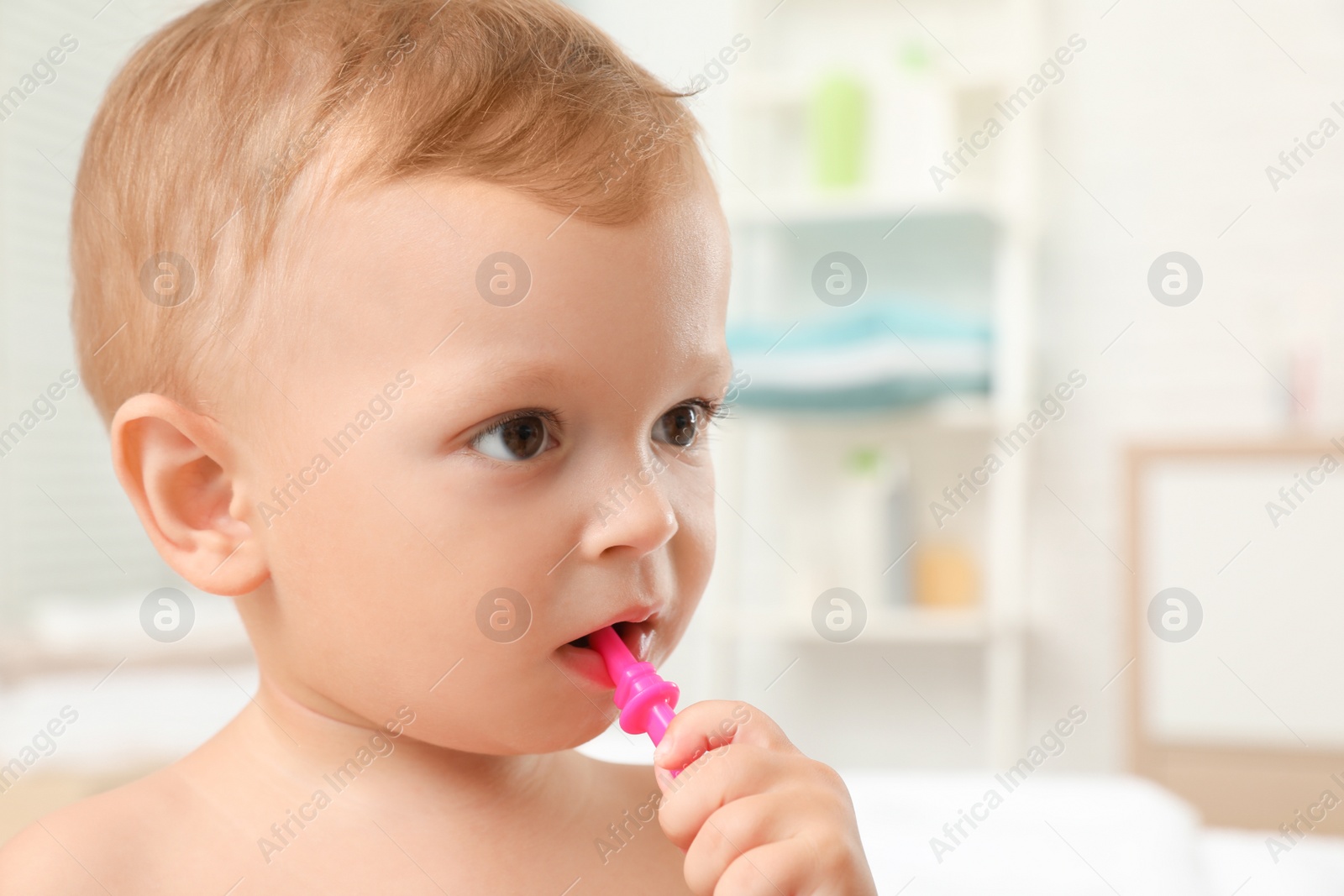 Photo of Cute little boy with toothbrush on blurred background