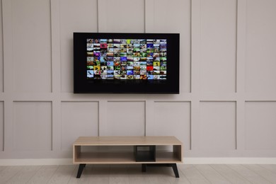 Photo of Modern TV on white wall in room