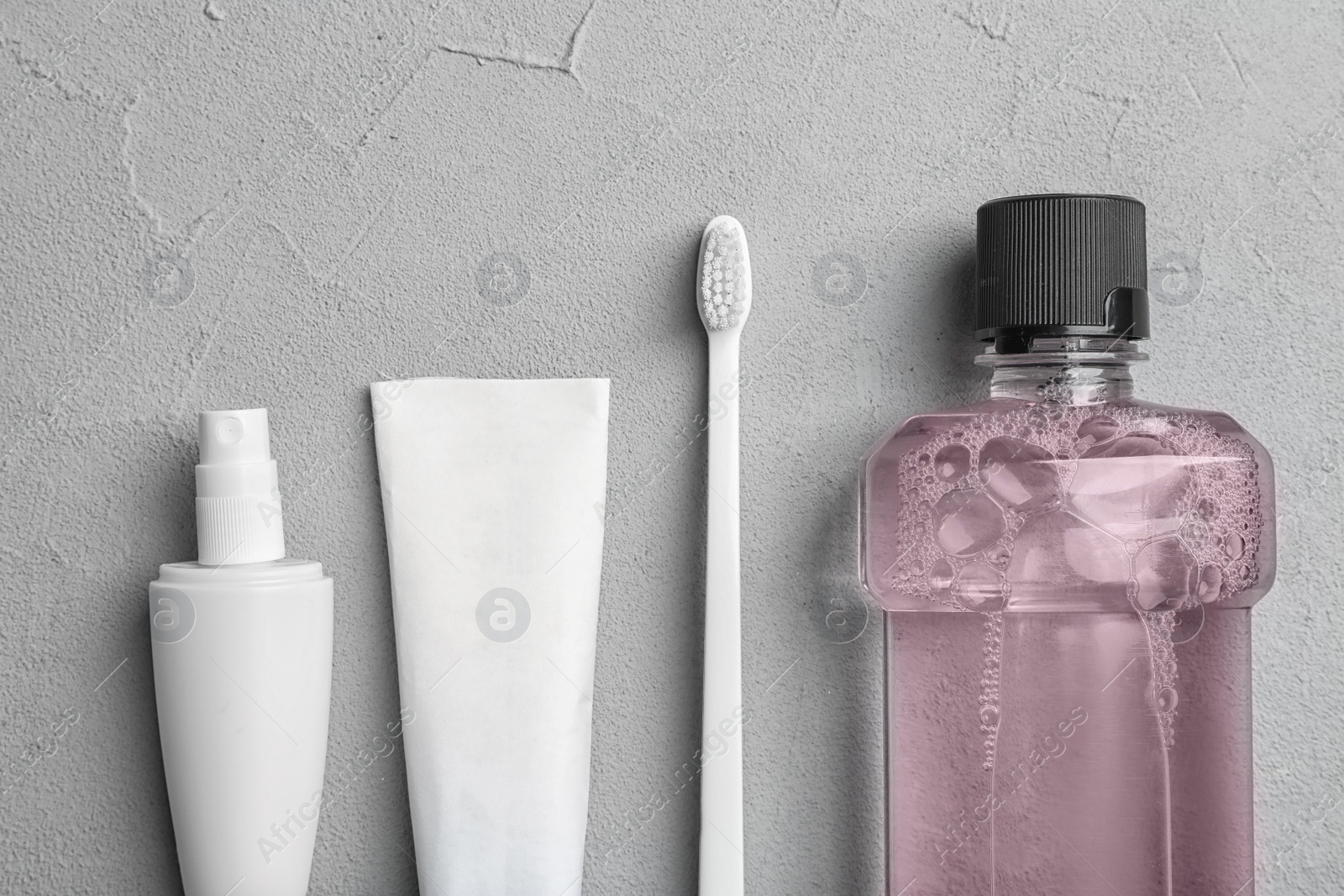 Photo of Flat lay composition with oral care  products on light background. Teeth hygiene