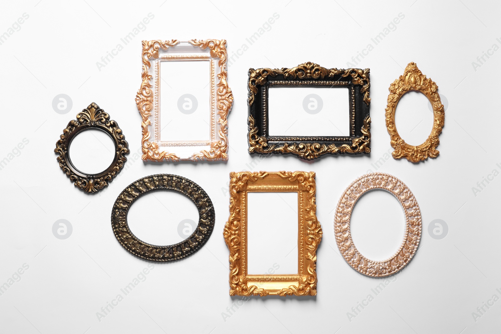 Photo of Blank vintage frames hanging on white wall