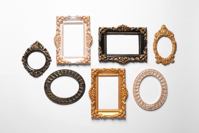 Photo of Blank vintage frames hanging on white wall