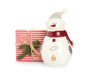 Photo of Decorative snowman near gift box on white background