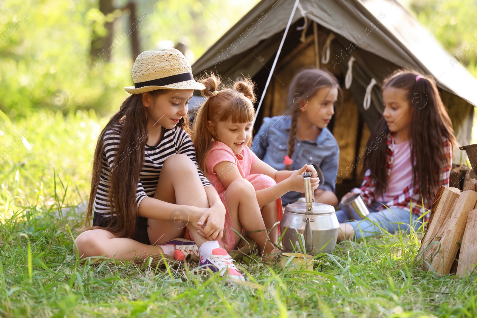 Photo of Little children near tent outdoors. Summer camp