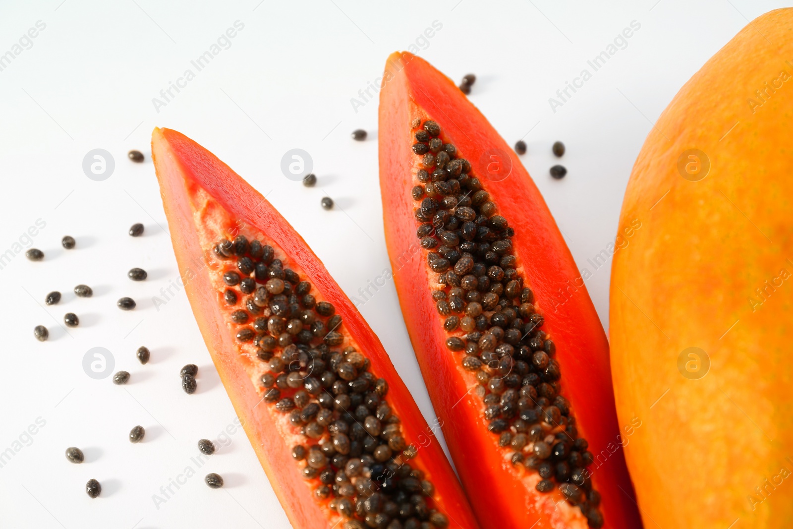 Photo of Fresh juicy cut and whole papaya fruits on white background, flat lay