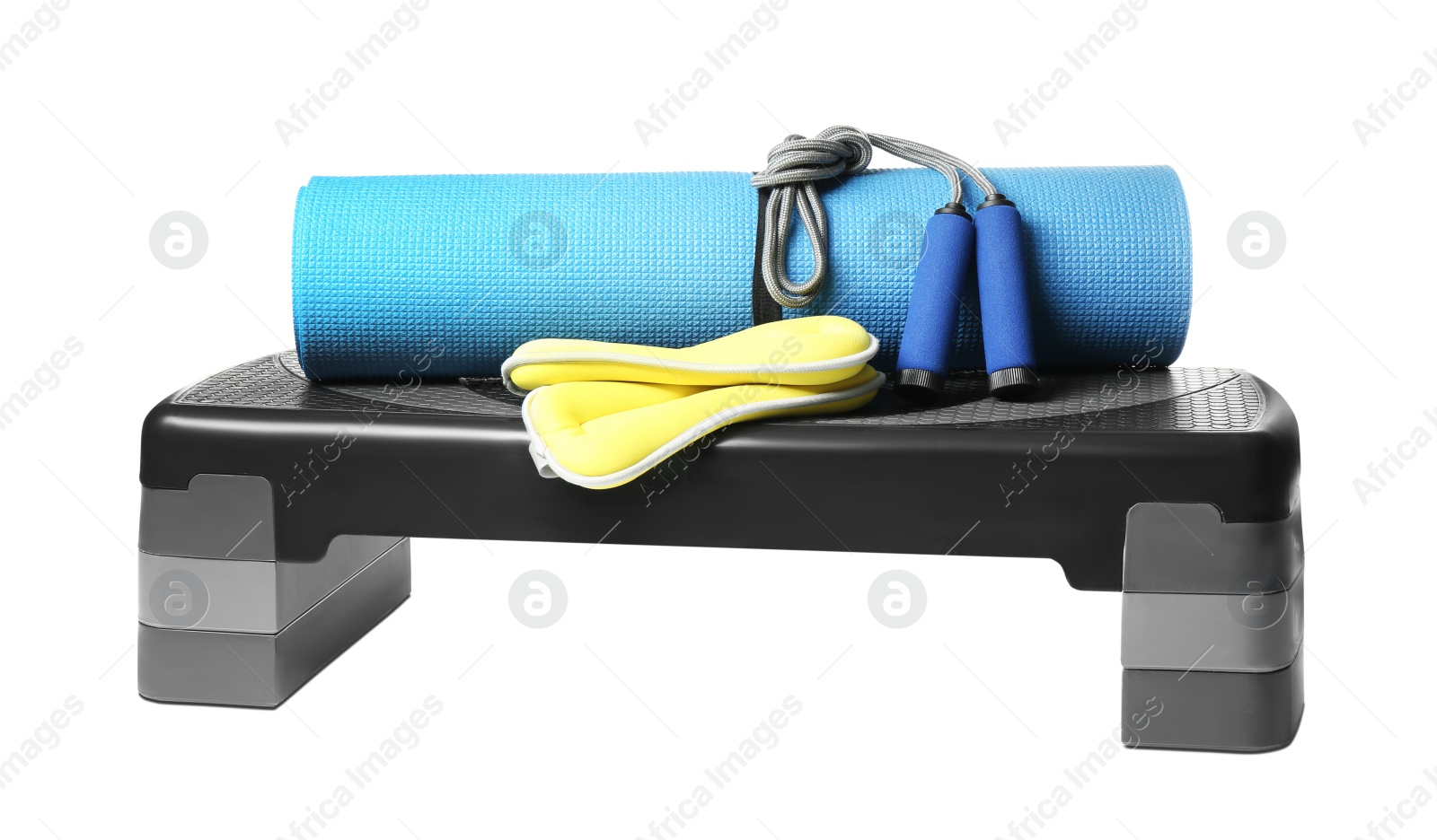 Photo of Step platform, mat, weights and jump rope on white background. Sports equipment