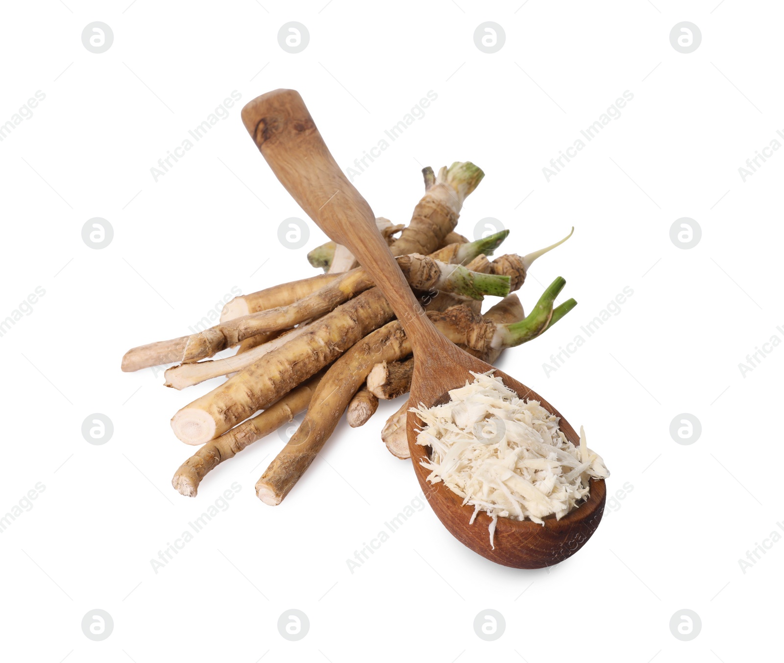 Photo of Spoon with grated horseradish and roots isolated on white