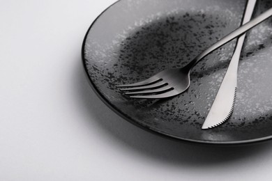 Photo of Setting with stylish cutlery on grey table, closeup. Space for text