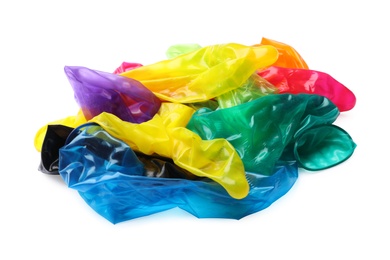 Pile of unrolled bright condoms on white background. Safe sex