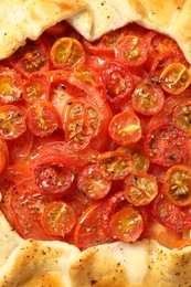 Tasty tomato galette (Caprese galette) as background, top view