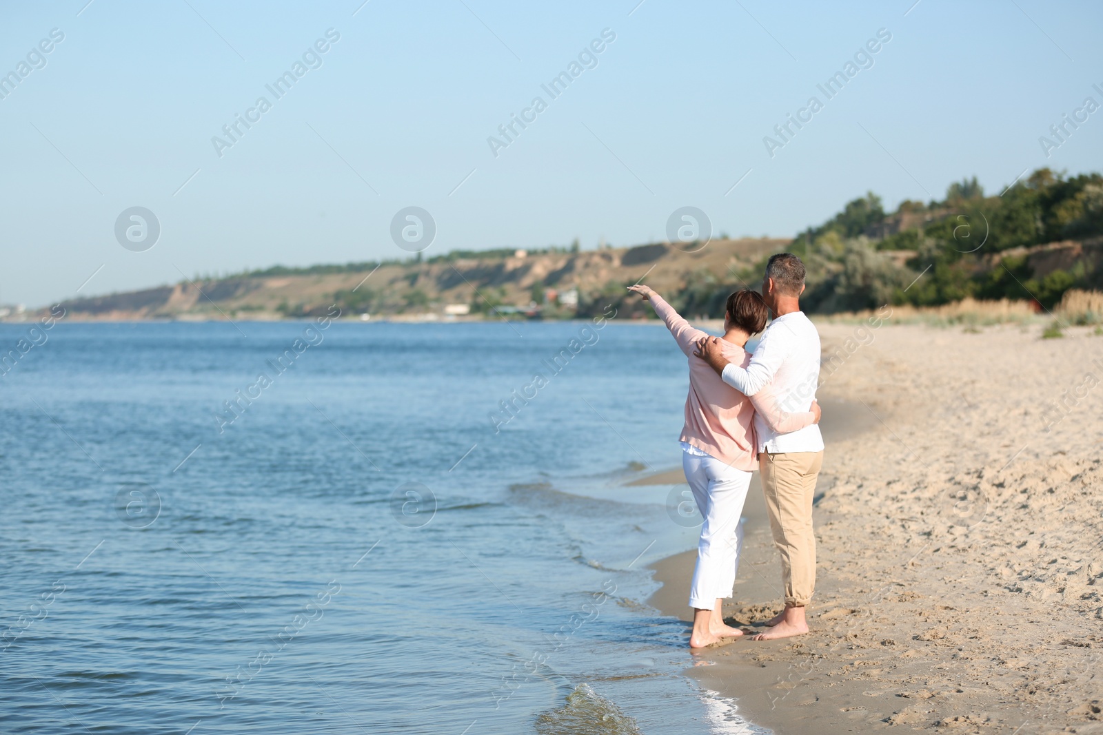 Photo of Happy mature couple at beach on sunny day