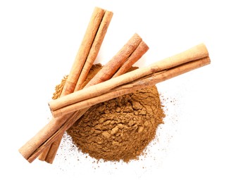 Photo of Dry aromatic cinnamon sticks and powder isolated on white, top view