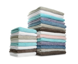 Different fresh soft terry towels on white background