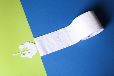Photo of Composition with toilet paper roll on color background, above view