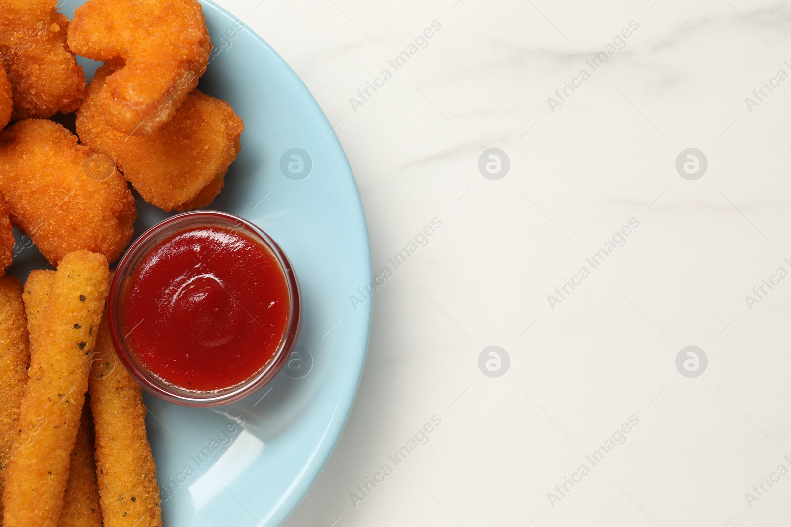 Photo of Plate with tasty ketchup, chicken nuggets and cheese sticks on marble table, top view. Space for text