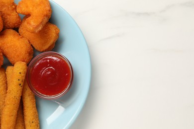 Photo of Plate with tasty ketchup, chicken nuggets and cheese sticks on marble table, top view. Space for text