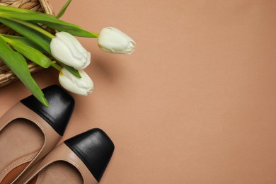 Photo of Pairnew stylish square toe ballet flats and beautiful tulips on beige background, flat lay. Space for text