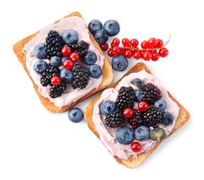 Photo of Tasty sandwiches with cream cheese and berries isolated on white, top view