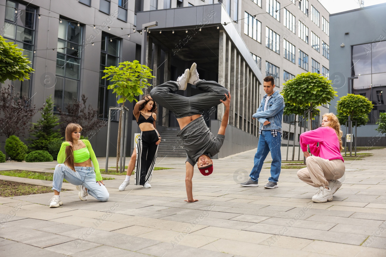 Photo of Group of people dancing hip hop outdoors, low angle view