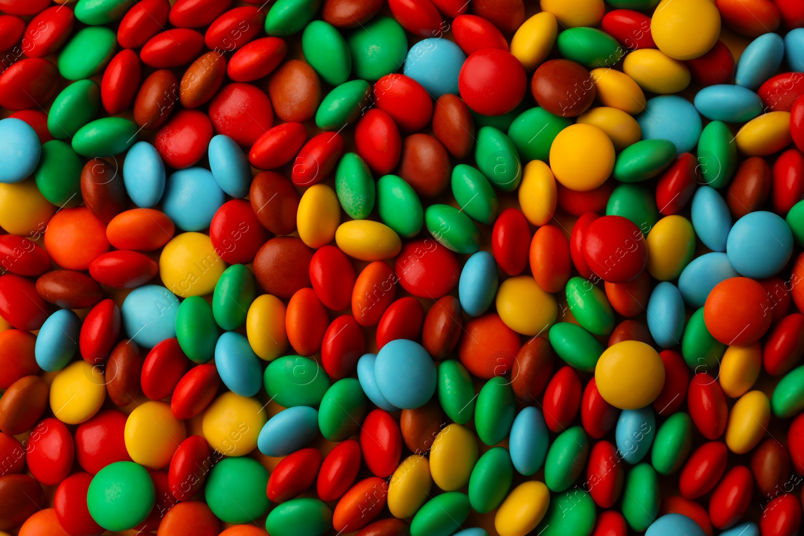 Photo of Tasty colorful candies as background, closeup view