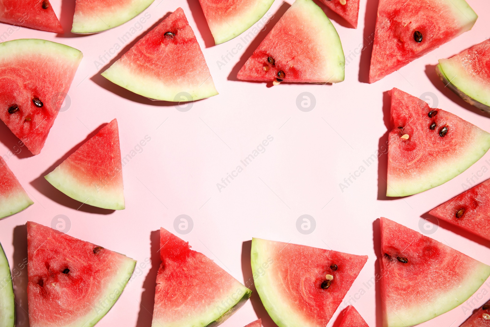 Photo of Frame of watermelon slices on pink background, flat lay. Space for text