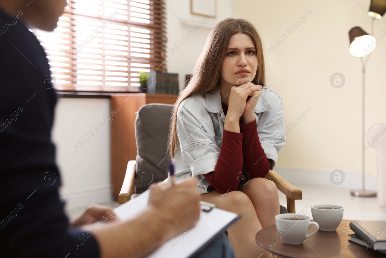 Photo of Professional psychotherapist working with patient in office