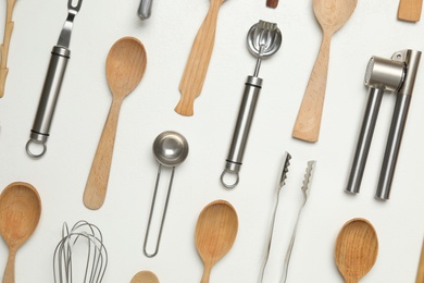 Photo of Set of cooking utensils on white background, flat lay