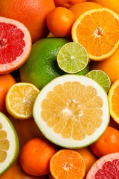 Photo of Different ripe citrus fruits as background, top view