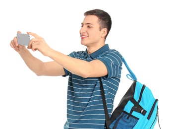 Young handsome man taking selfie against white background