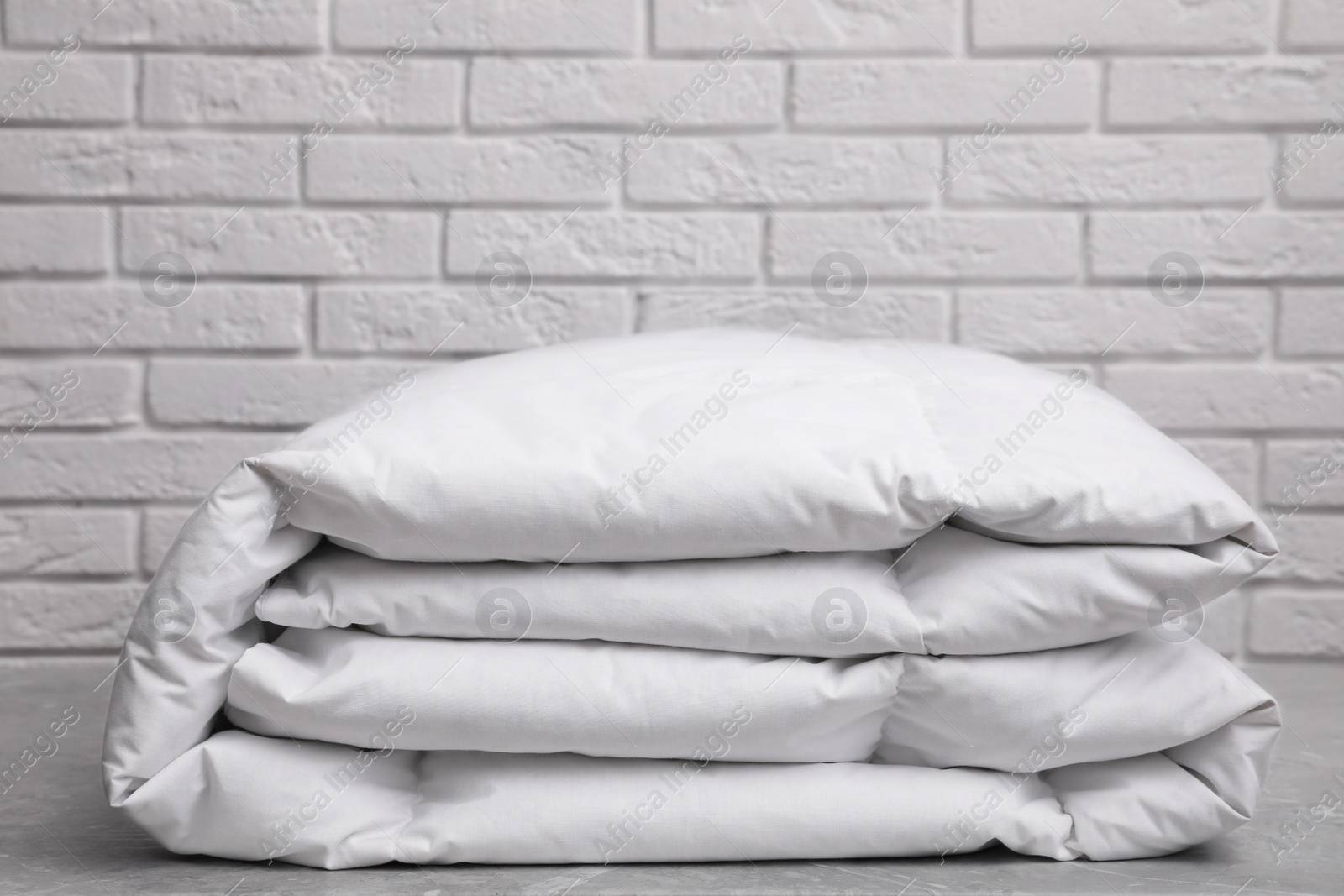 Photo of New soft folded blanket on table, closeup