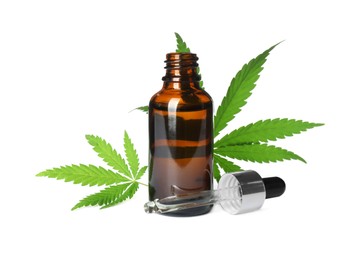 Photo of Bottle of CBD oil or THC tincture and hemp leaves on white background