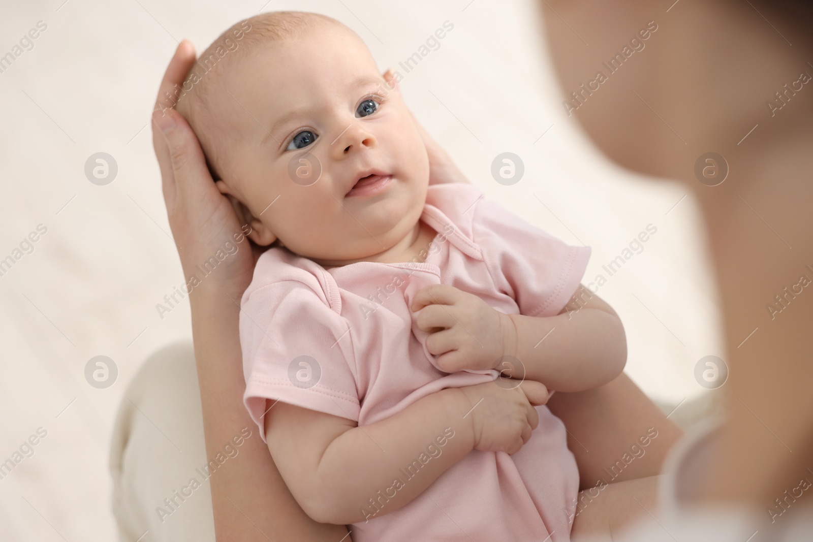 Photo of Mother with her cute little baby at home