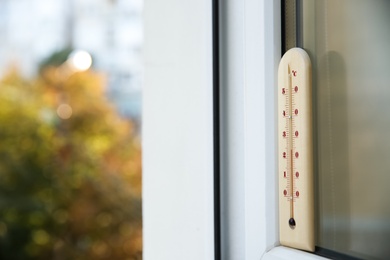 Weather thermometer on outside window. Space for text