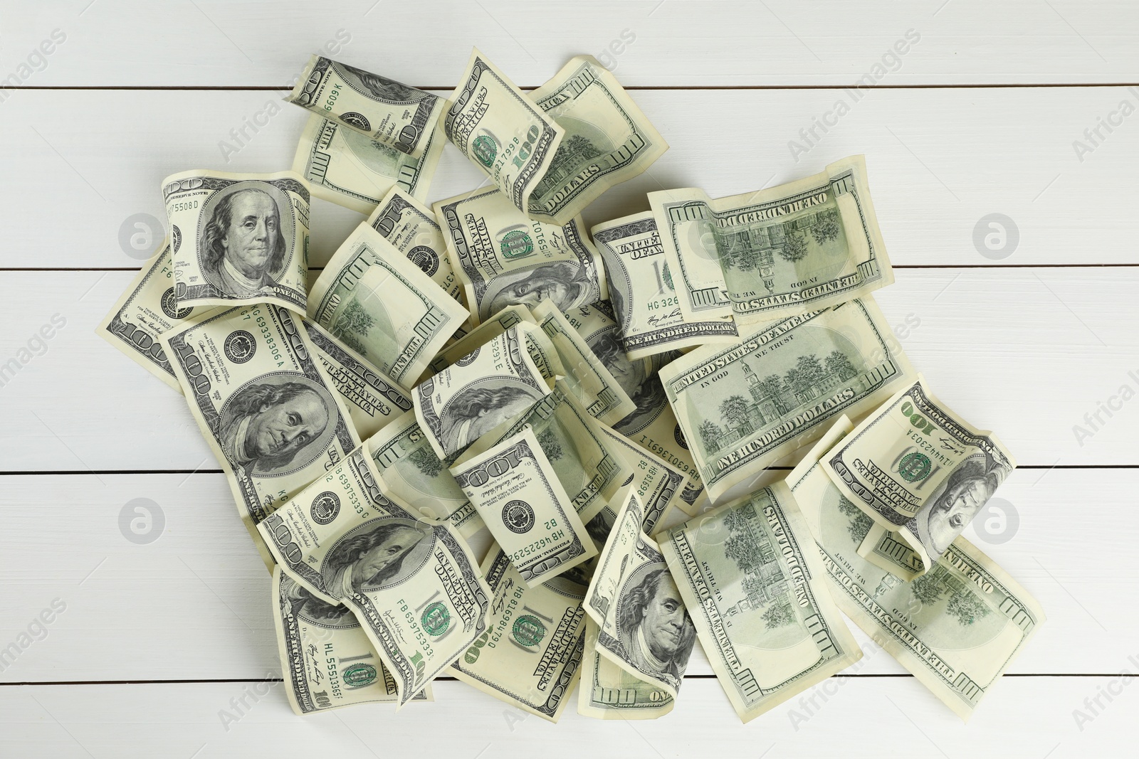 Photo of Money exchange. Dollar banknotes on white wooden background, top view