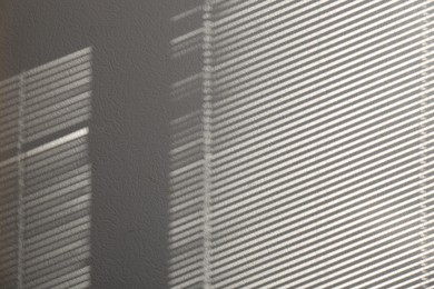 Photo of Light and shadow from window on white wall, space for text