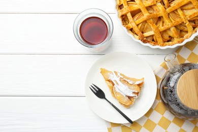 Piece of tasty homemade quince pie with powdered sugar served on white wooden table, flat lay. Space for text