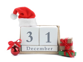 Photo of Wooden block calendar, Christmas ball, Santa hat and gifts on white background. New Year countdown