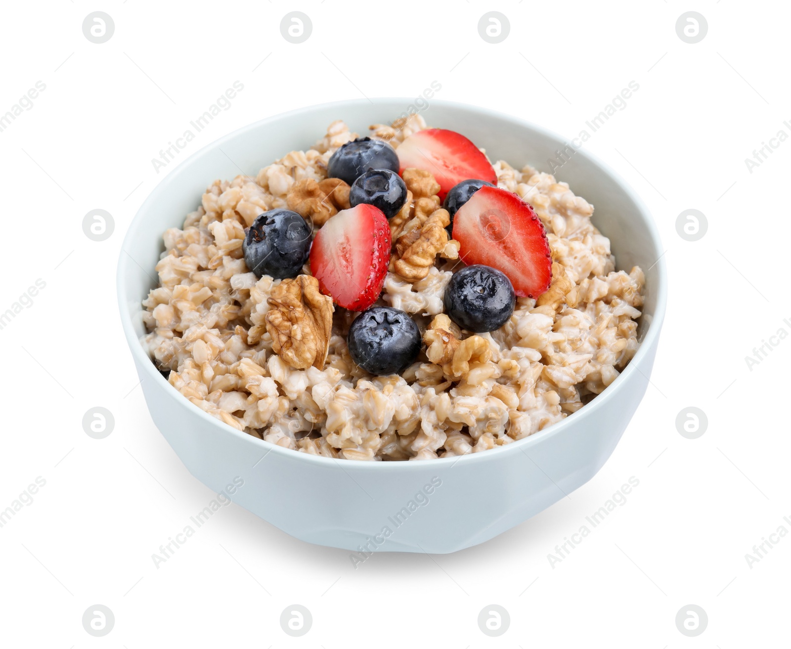 Photo of Tasty oatmeal with strawberries, blueberries and walnuts in bowl isolated white